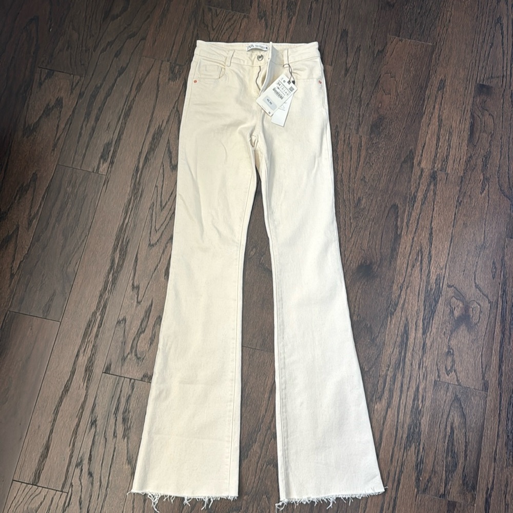 Zara ecru flare leg jeans. Never worn. New with tags. Raw hem. Can cut to size.
